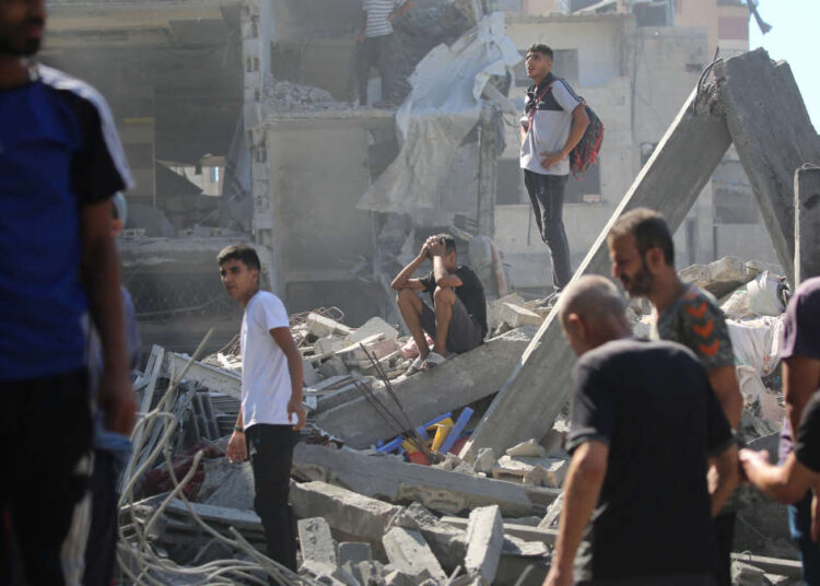 Palestinians inspect the damage after an Israeli strike in the Al-Bureij camp in the central Gaza Strip on July 4, 2025. (Photo by Eyad BABA / AFP)
